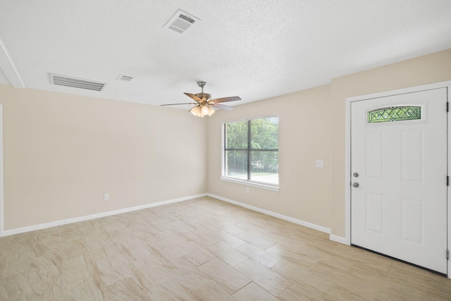3335 Rolling Hills Cir, Bonifay, FL 32425 - foyer with visible vents, baseboards, a textured ceiling, and ceiling fan