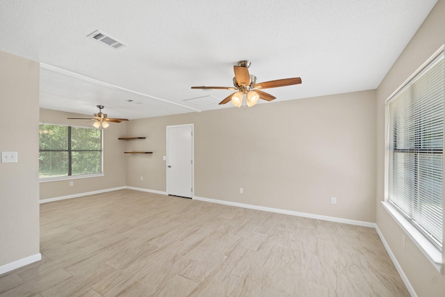 3335 Rolling Hills Cir, Bonifay, FL 32425 - unfurnished room with ceiling fan, a textured ceiling, visible vents, attic access, and baseboards