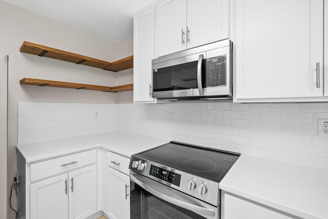 3335 Rolling Hills Cir, Bonifay, FL 32425 - kitchen with white cabinets, open shelves, decorative backsplash, and stainless steel appliances