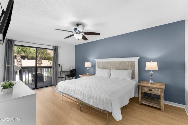 bedroom featuring baseboards, access to outside, wood finished floors, and a ceiling fan