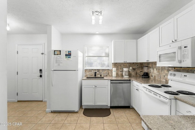 kitchen featuring white cabinets, white appliances, a sink, and backsplash