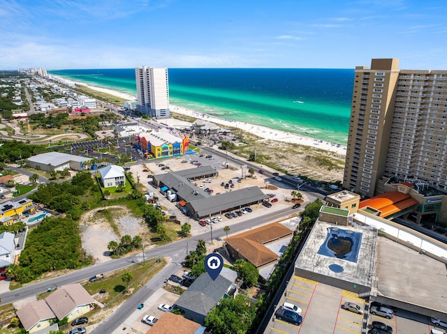 aerial view with a water view and a beach view