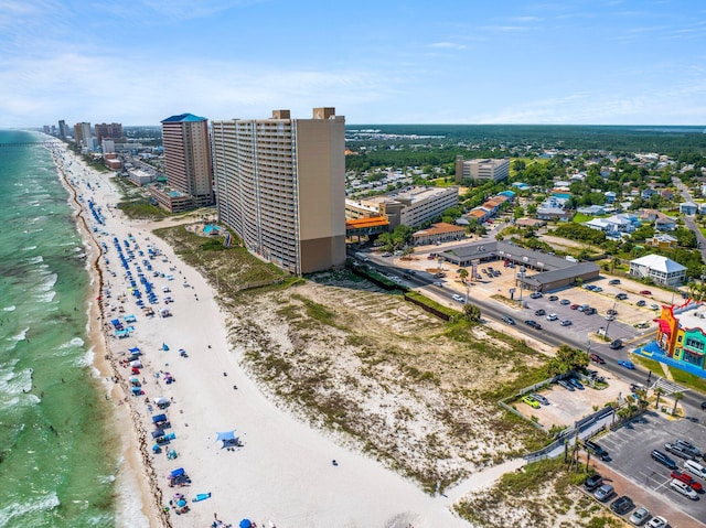 drone / aerial view with a water view, a city view, and a beach view