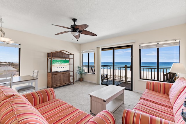 468 Abalone Ct Unit 31, Fort Walton Beach, FL 32548 - living area with a textured ceiling, ceiling fan, light carpet, and baseboards