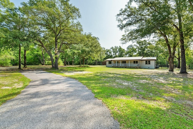 1259 Black Creek Blvd, Freeport, FL 32439 - view of front of property featuring a front yard and asphalt driveway