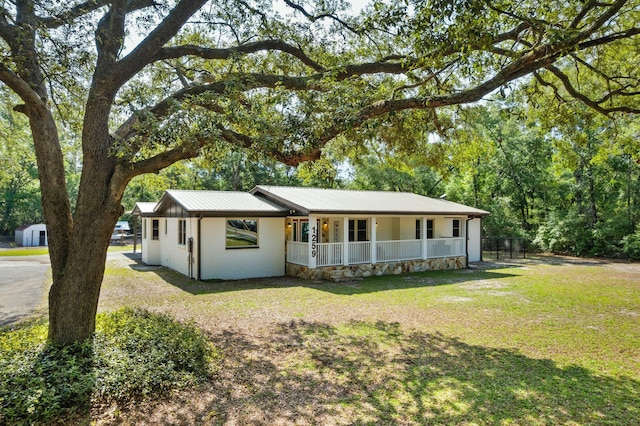 1259 Black Creek Blvd, Freeport, FL 32439 - single story home with a porch, a front lawn, and metal roof