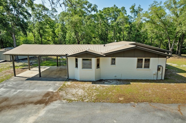 1259 Black Creek Blvd, Freeport, FL 32439 - single story home with brick siding, asphalt driveway, and metal roof
