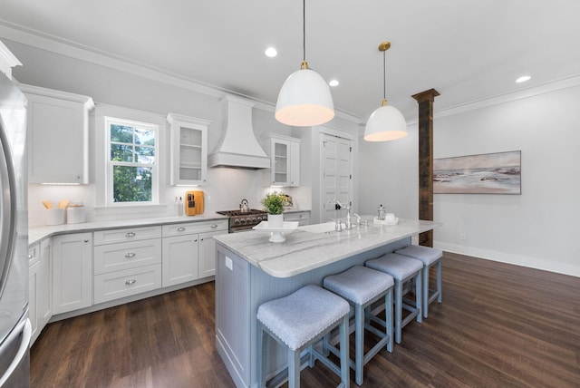205 Mallard Ln, Santa Rosa Beach, FL 32459 - kitchen with white cabinets, a kitchen breakfast bar, dark wood-type flooring, and premium range hood