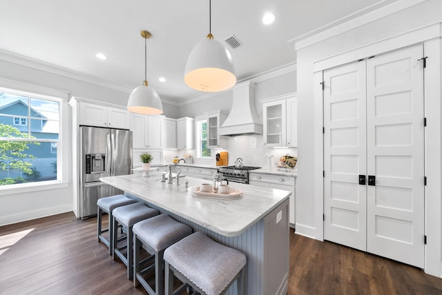 205 Mallard Ln, Santa Rosa Beach, FL 32459 - kitchen featuring white cabinets, backsplash, visible vents, premium range hood, and appliances with stainless steel finishes