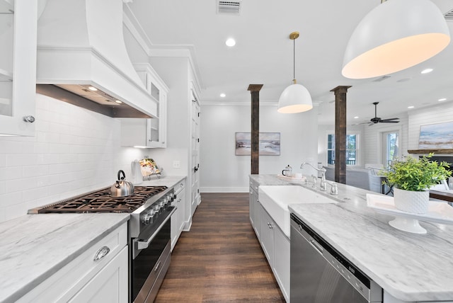 205 Mallard Ln, Santa Rosa Beach, FL 32459 - kitchen with stainless steel appliances, visible vents, a sink, premium range hood, and decorative columns