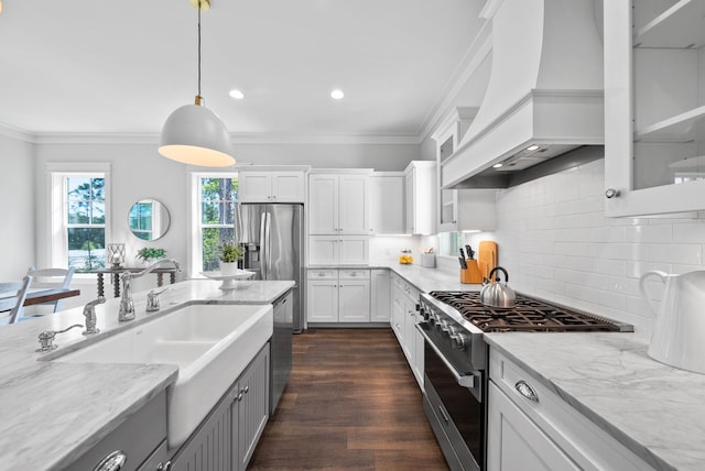 205 Mallard Ln, Santa Rosa Beach, FL 32459 - kitchen with light stone countertops, custom range hood, white cabinetry, and appliances with stainless steel finishes