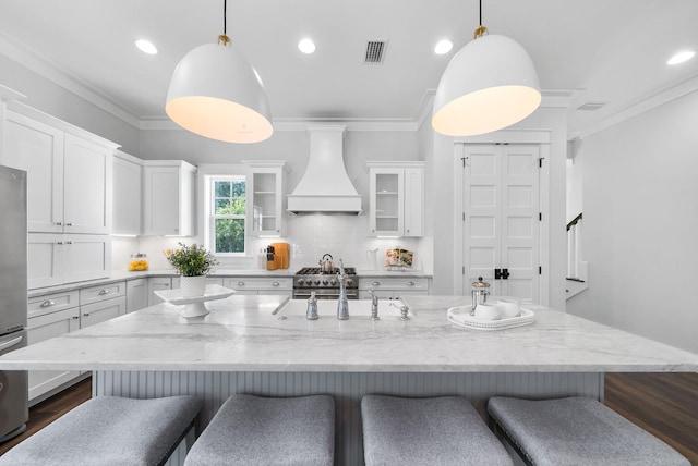 205 Mallard Ln, Santa Rosa Beach, FL 32459 - kitchen with white cabinets, visible vents, ornamental molding, and premium range hood