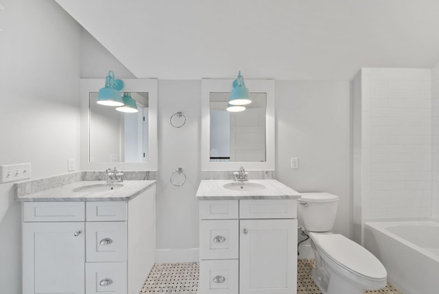 205 Mallard Ln, Santa Rosa Beach, FL 32459 - bathroom featuring two vanities, toilet, baseboards, and a sink
