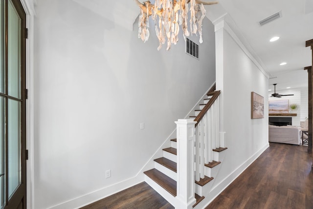205 Mallard Ln, Santa Rosa Beach, FL 32459 - stairs featuring a tile fireplace, wood finished floors, visible vents, and baseboards