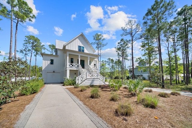 205 Mallard Ln, Santa Rosa Beach, FL 32459 - view of front of home with driveway, board and batten siding, a porch, a garage, and stairs
