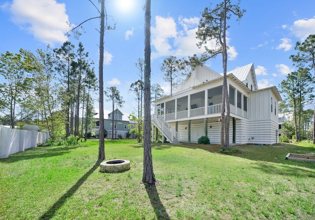 205 Mallard Ln, Santa Rosa Beach, FL 32459 - back of house with a fire pit, a sunroom, a yard, and board and batten siding