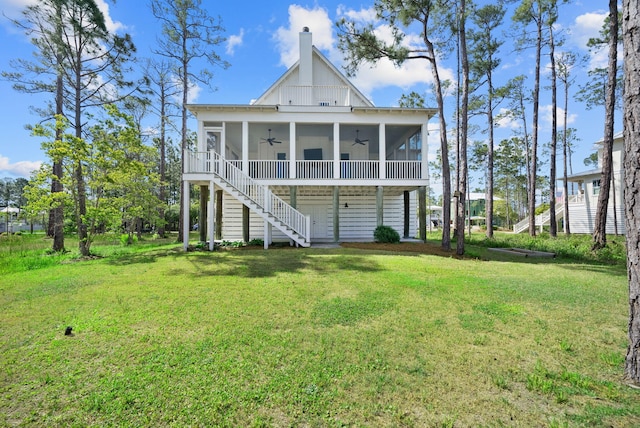 205 Mallard Ln, Santa Rosa Beach, FL 32459 - rear view of house with a yard, a sunroom, and a ceiling fan