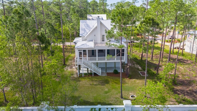 205 Mallard Ln, Santa Rosa Beach, FL 32459 - back of property featuring a lawn, a sunroom, stairs, and metal roof