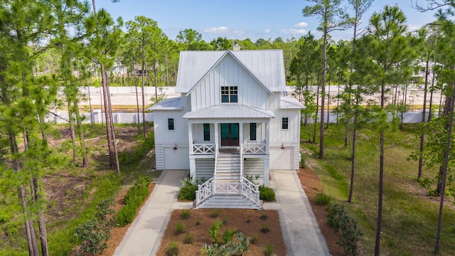 205 Mallard Ln, Santa Rosa Beach, FL 32459 - back of house with a garage, driveway, a porch, metal roof, and stairs