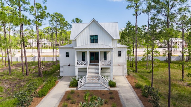 205 Mallard Ln, Santa Rosa Beach, FL 32459 - rear view of property with driveway, metal roof, a porch, a garage, and stairs