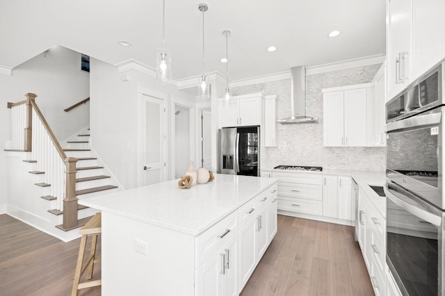 kitchen with crown molding, dark wood-style floors, wall chimney range hood, and stainless steel appliances