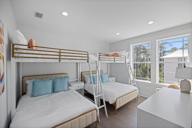 bedroom with wood finished floors, visible vents, recessed lighting, and baseboards