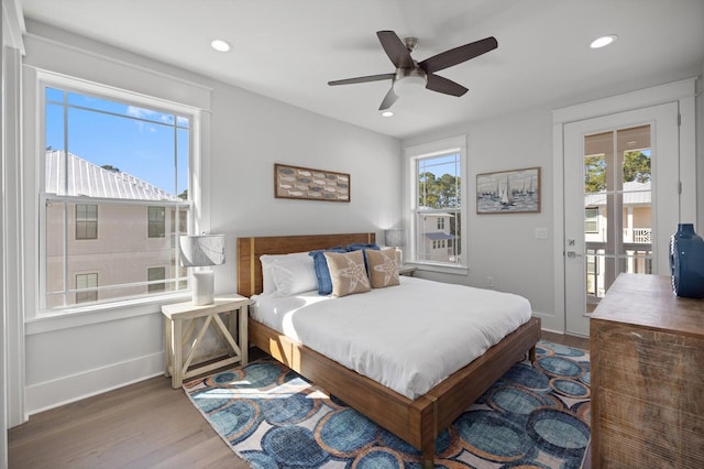 bedroom featuring recessed lighting, multiple windows, wood finished floors, and baseboards