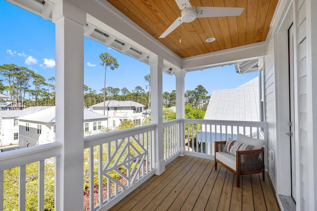 wooden terrace featuring ceiling fan and a residential view