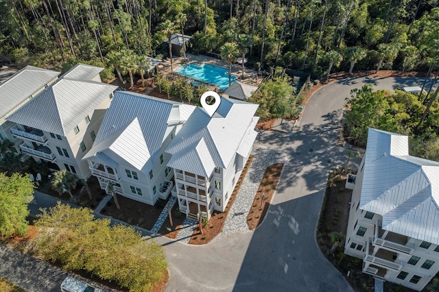 birds eye view of property with a wooded view