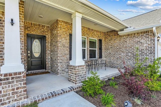 3291 Secret Isle Way, Navarre, FL 32566 - view of exterior entry featuring a porch, brick siding, and a shingled roof