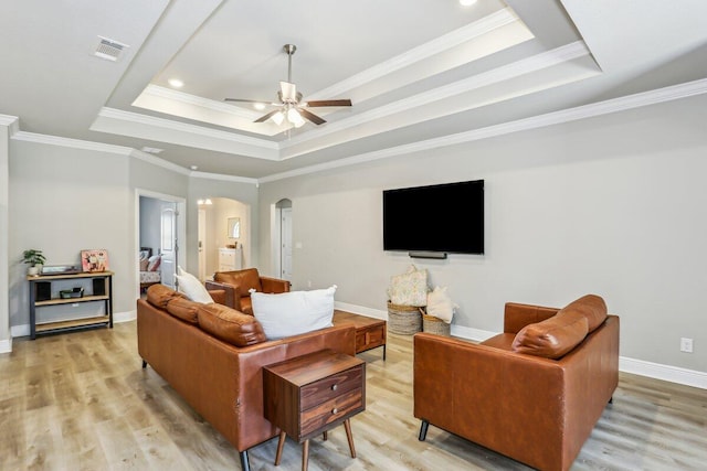 3291 Secret Isle Way, Navarre, FL 32566 - living area featuring a raised ceiling, arched walkways, ceiling fan, light wood-type flooring, and ornamental molding