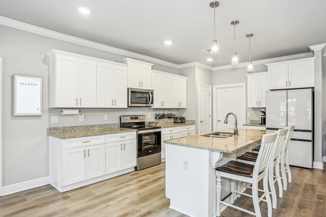 3291 Secret Isle Way, Navarre, FL 32566 - kitchen with stainless steel appliances, a sink, white cabinetry, crown molding, and a breakfast bar