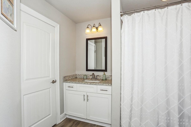 3291 Secret Isle Way, Navarre, FL 32566 - bathroom with vanity, wood finished floors, and curtained shower
