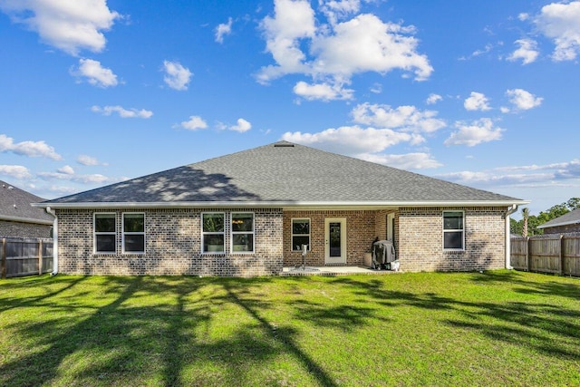 3291 Secret Isle Way, Navarre, FL 32566 - back of house with brick siding, roof with shingles, and a patio area
