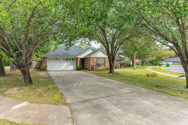 ranch-style home featuring concrete driveway, an attached garage, fence, a front yard, and brick siding