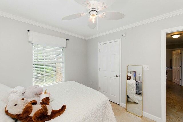 bedroom with a ceiling fan, baseboards, and crown molding