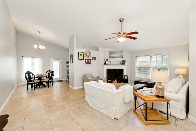 living area featuring lofted ceiling, a healthy amount of sunlight, and light tile patterned flooring