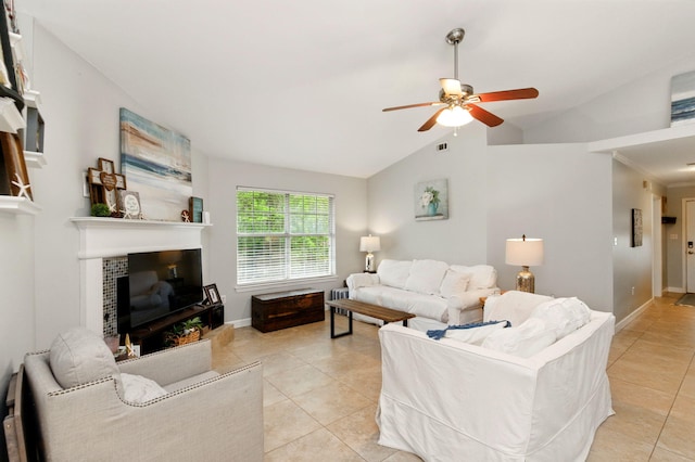 living room featuring lofted ceiling, a ceiling fan, light tile patterned floors, baseboards, and a fireplace