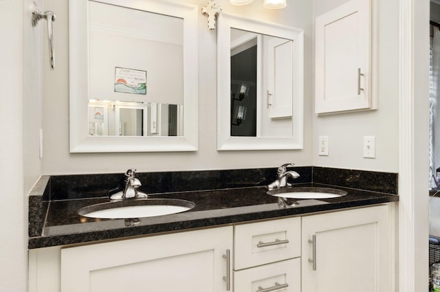 bathroom featuring double vanity, a sink, and ornamental molding