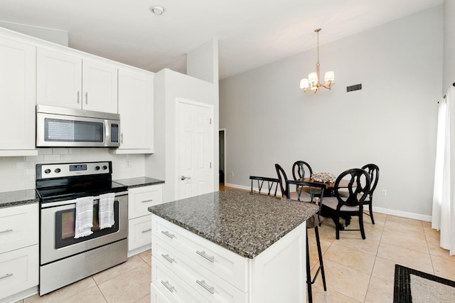 kitchen with stainless steel appliances, visible vents, an inviting chandelier, white cabinetry, and light tile patterned floors