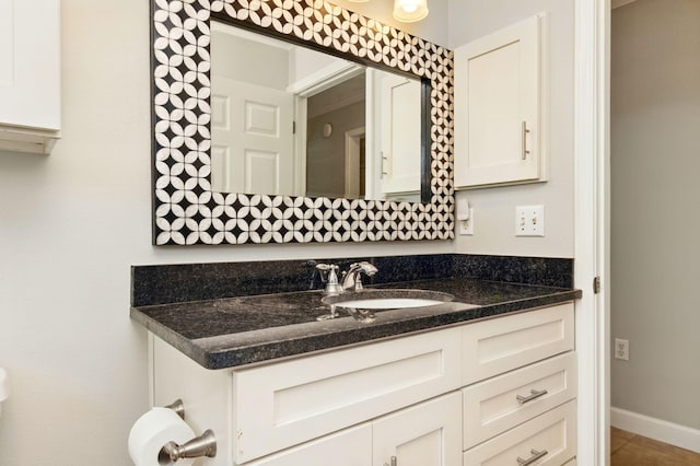 bathroom with baseboards and vanity