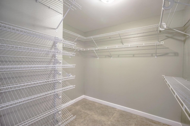 spacious closet with tile patterned floors