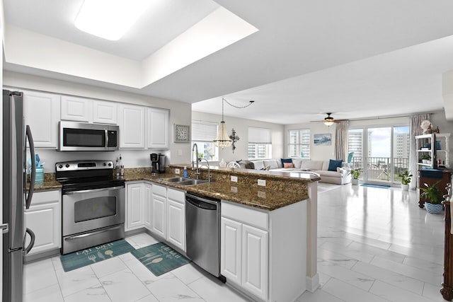 122 Seascape Dr Unit 701, Miramar Beach, FL 32550 - kitchen with a sink, open floor plan, a peninsula, stainless steel appliances, and marble finish floor