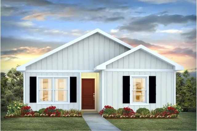 view of front of property with board and batten siding and a front lawn