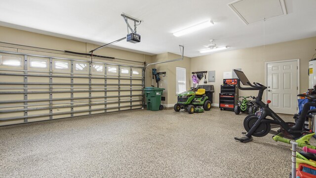 554 Magnolia Lake Dr, Defuniak Springs, FL 32433 - garage featuring electric panel, water heater, a garage door opener, and baseboards