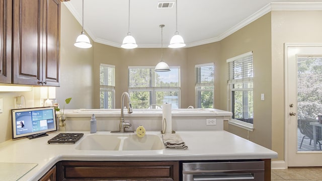 554 Magnolia Lake Dr, Defuniak Springs, FL 32433 - kitchen with ornamental molding, light countertops, a sink, a peninsula, and decorative light fixtures