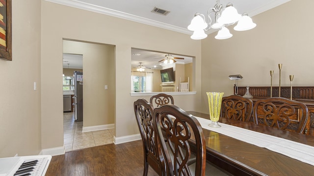 554 Magnolia Lake Dr, Defuniak Springs, FL 32433 - dining space with crown molding, plenty of natural light, a chandelier, a ceiling fan, and wood finished floors