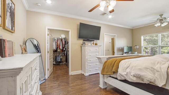 554 Magnolia Lake Dr, Defuniak Springs, FL 32433 - bedroom with a spacious closet, ornamental molding, dark wood finished floors, a closet, and ceiling fan