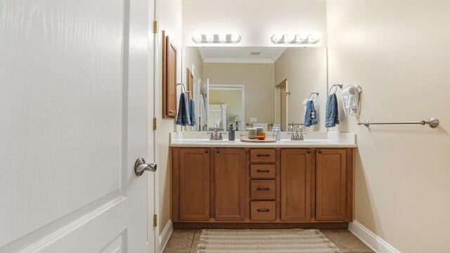 554 Magnolia Lake Dr, Defuniak Springs, FL 32433 - bathroom with crown molding, double vanity, baseboards, and tile patterned flooring