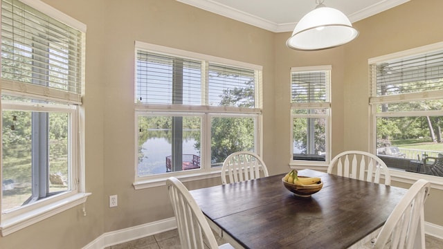 554 Magnolia Lake Dr, Defuniak Springs, FL 32433 - dining room with baseboards, tile patterned flooring, crown molding, and a water view